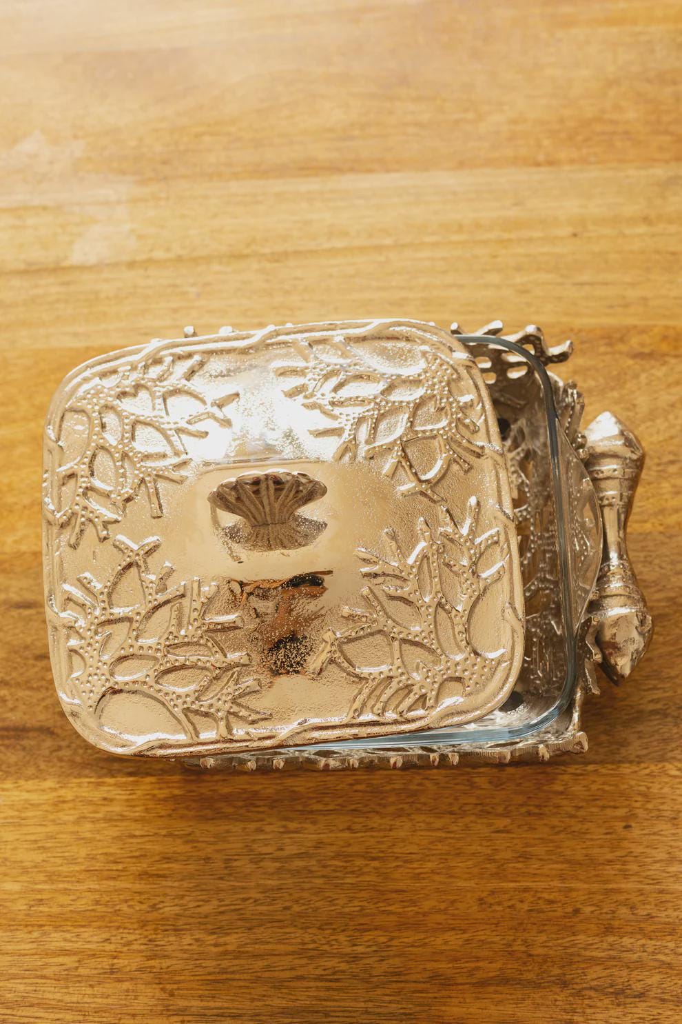 Coastal themed casserole dish, featuring a glass bottom and metal lid and stand