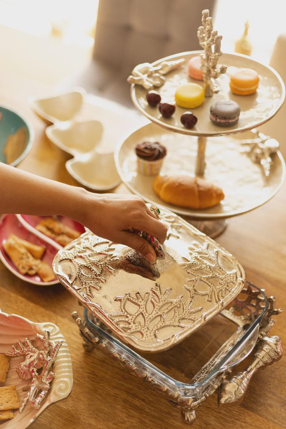 Coastal themed casserole dish, featuring a glass bottom and metal lid and stand