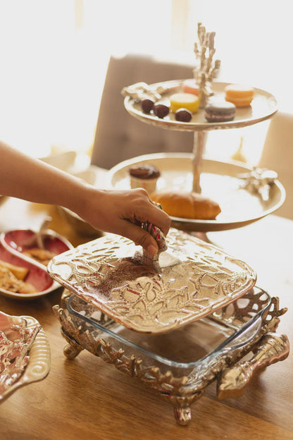 Coastal themed casserole dish, featuring a glass bottom and metal lid and stand